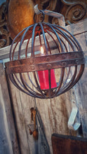 Load image into Gallery viewer, Antique Iron globe Candle Gimbal Lantern Primitive Rustic Farmhouse decor hanging on painted iron hook with primited white painted farmhouse door in background dusty gems interiors nantwich