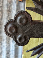 Load image into Gallery viewer, Late 18th century French provincial tinned altar cross with trefoil terminals and radiating glory standing on a rustic green painted wooden table against weathered painted boards and dried flowers.