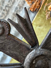 Load image into Gallery viewer, Late 18th century French provincial tinned altar cross with trefoil terminals and radiating glory standing on a rustic green painted wooden table against weathered painted boards and dried flowers.