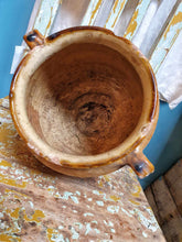 Load image into Gallery viewer, French antique 19th century confit pot with mustard glaze filledwith sunflowers. sitting ontop of a Swedish antique pantedfarmhouse chair with light blue chippy paint. behind is old antique french linen shirs hanging up. Dusty gems interiors nantwich cheshire