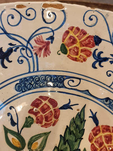 Decorative ceramic plate with floral patterns and blue accents