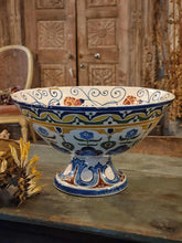 Load image into Gallery viewer, Antique Italian Deruta majolica bowl (yellow, blue, green) sitting on a rustic duck egg blue chopping board next to a bunch of dried sunflowers. The display is set on a weathered French workbench against a large, bleached-out Indian door.