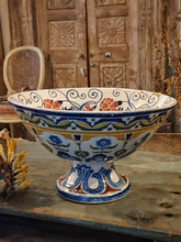 Load image into Gallery viewer, Antique Italian Deruta majolica bowl (yellow, blue, green) sitting on a rustic duck egg blue chopping board next to a bunch of dried sunflowers. The display is set on a weathered French workbench against a large, bleached-out Indian door.