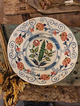 Load image into Gallery viewer, Decorative ceramic plate with floral patterns on a rustic wooden surface