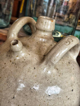 Load image into Gallery viewer, A 19th-century French walnut oil jar in buff terracotta with a thick cream tin glaze, showing a rustic, time-worn patina and simple provincial form.