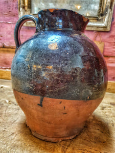 Antique Welsh Buckley Black Pottery Jug Rustic vernacular North wales flintshire jug sitting ontop of swedish painted marrage chest with french vintage linen in the background on french farmhouse rustic shelving in the dusty Gems interiors shop