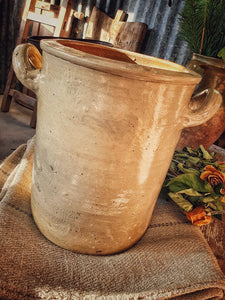  Antique French Confit pot Storage Jar Rustic country farmhouse kitchen confit pot sitting on french linen grain sack for french country look large french chopping board in background and dried roses primitive decor dusty gems interiors Nantwich 