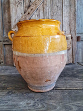 Load image into Gallery viewer, Antique French Large Confit pot Rustic Farmhouise mustard Glaze  Terracotta body sitting infront of french country primitive wooden shutters in the Dusty Gems interiors nantwich shop 