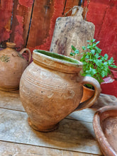 Load image into Gallery viewer, French Antique Rustic Confit Pot primitive Farmhouse kitchen olive pot sitting on french rustic country table with terracotta dairy bowl and large french cutting board and french mint plant in old pot all agaist a background of red painted rusic panel wall with flaking paint dusty gems interiors nantwich 
