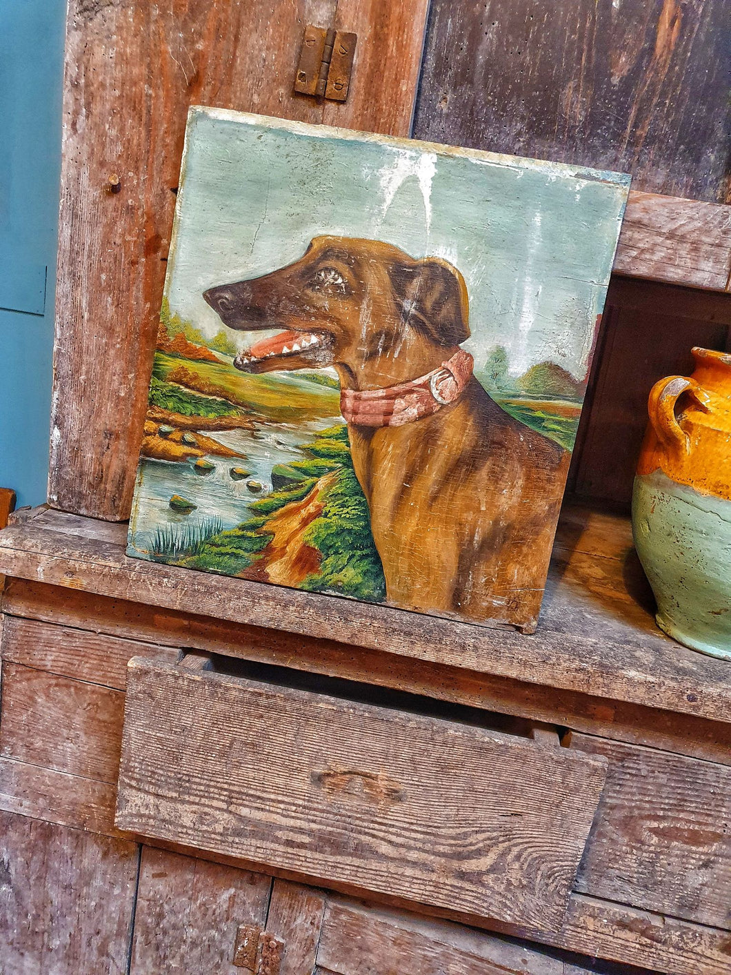 Antique 19th Century Oil On wood Panel Lurcher Dog primitive Folk Art oil painting sitting on Antique rustic swedish country cupboard next to antique french confit pot dusty gems intriors nantwich 