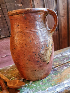 Antique French Country Rustic Cider Jug 19th Century Farmhouse sitting on antique Swedish painted farmhouse bench with antique handcarved spoons next to the Jug overall primitive farmhouse kitchen look Dusty Gems Interiors Nantwich 