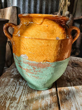 Load image into Gallery viewer, Antique French Country Pottery Confit Pot Storagr Jar Mustard Glaze with painted mint green bottom in french rustic kitchen sitting on worn painte farmhouse rustic table with french farmhouse chopping board cutting board French kitchen cermamics Dusty Gems Interiors Nantwich