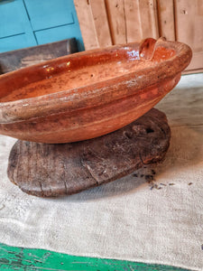 French Antique 19th Century Gassoutlet Dairy Bowl rustic Farmhouse provence pottery brown glazed terracotta sitting on red painted french farmhouse bench primitive wooden kitchen behind bowl is filled with oranges dusty gems interiors nantwich