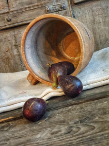 Antique French Country Rustic Terracotta Farmhouse Hand Made Jug sitting on french farmhouse table along with french 19th century linen with four fresh figs on top with a background of painted french farmhouse shutters dusty Gems interiors nantwich