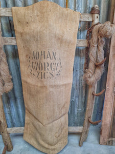 Antique Hungarian Rustic Linen Hemp Grain sack Farmhouse Laundry Bag Hand woven handsewn rustic vintage linen on French country split leg stool grain sack fabric dusty gems interiors nantwich antiques