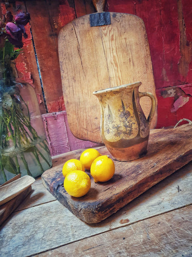 Antique French Cream Pot storage pot  Rustic country Farmhouse Confit Pot 19th Century. yellow and green glaze. sitting on french 19th century copping board with lemons and another french farmhouse cutting board in the background dusty gems interiors Nantwich 