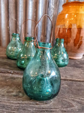 Load image into Gallery viewer, Antique Spanish green  Glass Wasp Trap Rustic French Country cottage Garden sitting on a wooden rustic french farmhouse table with a green glass french storage jar with wellow flowers in it  French country garden dusty gems interiors nantwich