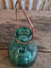 Load image into Gallery viewer, Antique Spanish green  Glass Wasp Trap Rustic French Country cottage Garden sitting on a wooden rustic french farmhouse table with a green glass french storage jar with wellow flowers in it  French country garden dusty gems interiors nantwich